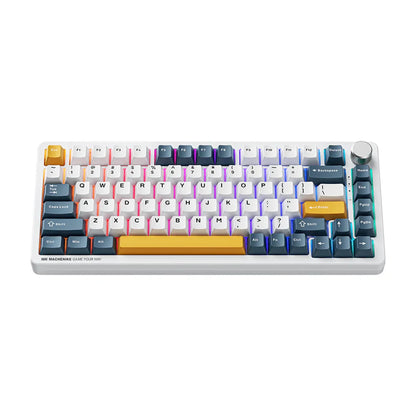 future tech gadgets Canada. premium tech accessories Canada. Machenike K600-B82W RGB Mechanical Keyboard. Gallery image 1. The keyboard is positioned centrally in the frame, showcasing a compact design with a white base. The keys feature a vibrant color scheme, including shades of blue, yellow, and pink, with a mix of white and dark accents. A large, textured volume knob is located on the top right corner. The lighting is bright and even, highlighting the glossy finish of the keys.