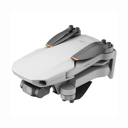 future tech gadgets Canada. cutting edge electronics online Canada. DJI Mini 4K Quadcopter Drone with Camera & Controller. Gallery image 2. The drone is positioned at a slight angle, showcasing its compact, folded design. It features a sleek, matte white body with gray accents and orange highlights on the propeller arms. The camera is visible at the front, along with a small lens and a status light. The background is a seamless white, emphasizing the drone's modern aesthetic.