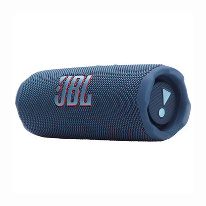 future tech gadgets Canada. smart tech store Canada. JBL Flip 7 Portable waterproof and drop-proof speaker. Gallery image 2. A cylindrical blue portable speaker is centered in the frame, showcasing its textured fabric surface. The prominent JBL logo is displayed in red on the side, while a control button with a triangular icon is visible on one end, surrounded by a rubberized edge. The background is a seamless white, enhancing the product's colors.
