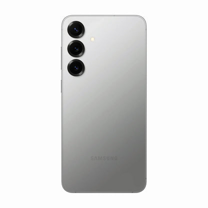 smart tech store Canada. premium tech accessories Canada. New Samsung Galaxy S25 Plus. Gallery image 8. The smartphone is centered in the frame, showcasing its sleek, matte silver back. Three circular camera lenses are aligned vertically on the left side, with a small flash positioned above them. The surface beneath the phone is a seamless white, enhancing the device's modern aesthetic. The lighting is soft, creating subtle reflections on the phone's surface.