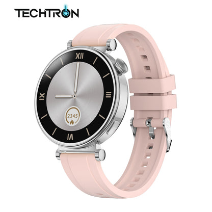 smart tech store Canada. premium tech accessories Canada. Techtron Aurafit AM23 Smart Watch. Gallery image 3. The smartwatch is positioned at a slight angle, showcasing its round face and pink silicone strap. The watch face features a sleek silver center with a black bezel, displaying Roman numerals and a digital readout of "2345" within a flame icon. The background is a seamless white, enhancing the watch's modern design.
