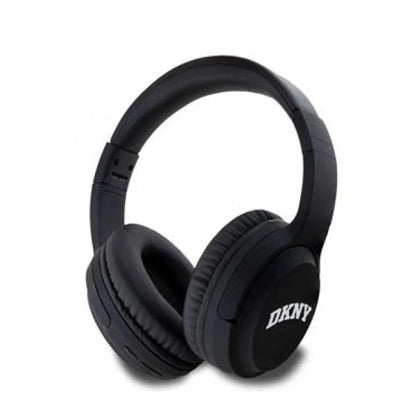 future tech gadgets Canada. premium tech accessories Canada. DKNY Headphones Bluetooth. Gallery image 1. The image features a pair of black over-ear headphones positioned at a slight angle, showcasing the ear cups and headband. The headphones rest on a plain white background, emphasizing their sleek design. The ear cups are cushioned and have a matte finish, while the headband is slightly glossy. The logo "DKNY" is prominently displayed in white on the right ear cup.