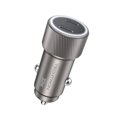 smart tech store Canada. premium tech accessories Canada. Techtron C-858 33W Dual USB-C Fast Car Adapter. Gallery image 1. The image features a sleek, metallic car charger positioned at an angle, showcasing its two USB-C ports at the top. The charger has a brushed silver finish with a textured, ribbed grip around the top edge. The brand name "TECHTRON" and "36W" are printed in a subtle, light gray on the side. The background is a seamless white, enhancing the product's modern design.