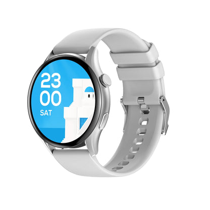 future tech gadgets Canada. smart tech store Canada. Techtron FAMO60 Fashion Smart Watch. Gallery image 2. The smartwatch is displayed at a slight angle, showcasing its round face and silver bezel. The screen features a bright blue background with the time displayed as "23:00" and the day "SAT," alongside a minimalist white architectural design. The strap is a soft, matte white material with cutouts for ventilation, and it connects to the watch body with a metal clasp.