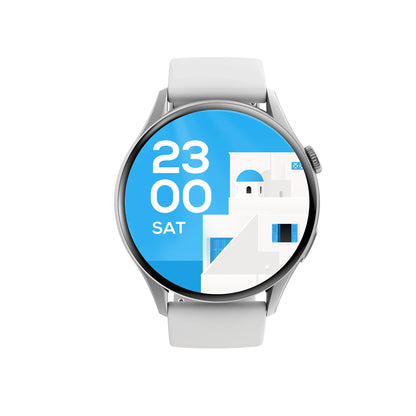 future tech gadgets Canada. smart tech store Canada. Techtron FAMO60 Fashion Smart Watch. Gallery image 10. The smartwatch is centered in the frame, showcasing a round display with a vibrant blue background. The screen features the time "23:00" and the day "SAT," alongside a stylized illustration of white buildings with blue accents, reminiscent of Mediterranean architecture. The watch has a sleek silver bezel and a matte white silicone strap.