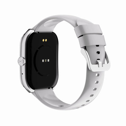 future tech gadgets Canada. smart tech store Canada. Techtron FAMO89 Fashion Smart Watch. Gallery image 13. The image shows a smartwatch positioned at a slight angle, revealing its sleek black back and a light gray silicone strap. The watch features a circular charging area with three small metal contacts and a prominent silver button on the side. The strap is secured with a silver buckle and has multiple holes for adjustment.