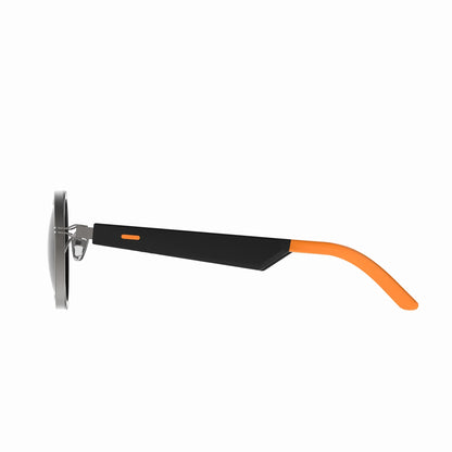 future tech gadgets Canada. smart tech store Canada. Techtron Oracle Smart Sunglasses. Gallery image 4. The image shows a pair of sunglasses viewed from the side, highlighting the sleek design. The frame is primarily black with a matte finish, featuring a vibrant orange accent on the temple. The lenses are dark and round, reflecting light softly. The background is a seamless white, emphasizing the product's colors and details.