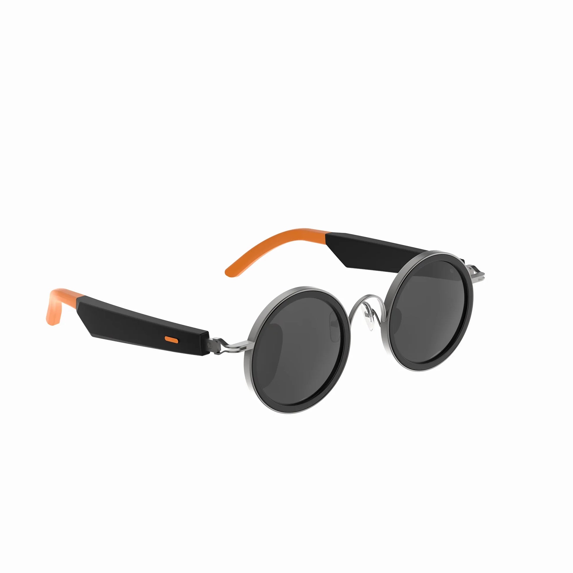 future tech gadgets Canada. smart tech store Canada. Techtron Oracle Smart Sunglasses. Gallery image 5. The sunglasses are displayed at a slight angle, showcasing their round lenses and sleek design. The frames are primarily black with glossy accents, while the temples feature vibrant orange tips. The lenses are dark, reflecting light subtly. The background is a seamless white, emphasizing the product's modern aesthetic. There are no visible logos or text on the sunglasses.