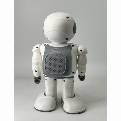 smart tech store Canada. premium tech accessories Canada. Techtron Jarvis AI Programming Educational Robot. Gallery image 3. The robot stands upright, centered in the frame against a plain light grey background. Its body is primarily white, with a grey speaker-like panel on its chest that features a grid pattern. The robot has a round head with a smooth surface and small black eyes, and its arms and legs are jointed, giving it a playful appearance.