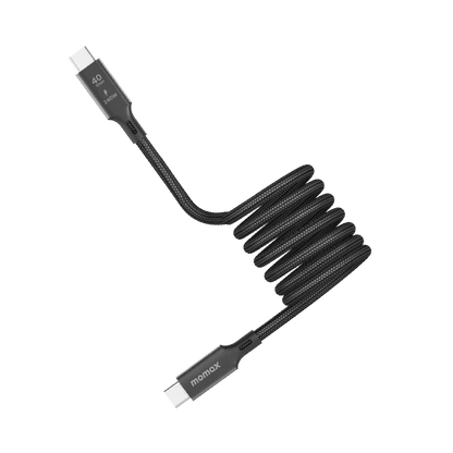 next gen electronics shop. buy electronics online Canada. Momax Mag.Link 240W Usb-C To Usb-C Usb 4 40Gbps Magnetic Cable 1.5M. Gallery image 1. A coiled black charging cable is prominently displayed against a white background. The cable features a textured fabric exterior, giving it a durable appearance. One end has a connector with a white tip, while the other end is slightly angled, showcasing the brand name "momax" printed in white.