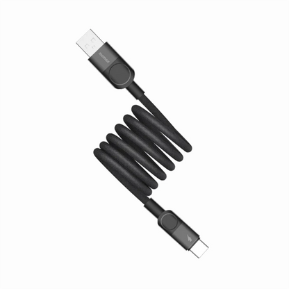 future tech gadgets Canada. premium tech accessories Canada. Momax Mag.Link 66W Usb-A To Usb-C Magnetic Cable 1M. Gallery image 6. A black, braided USB cable is coiled in the center of the frame, with one end featuring a standard USB connector and the other end a USB-C connector. The cable has a matte finish, giving it a textured appearance. The background is plain white, enhancing the visibility of the cable.