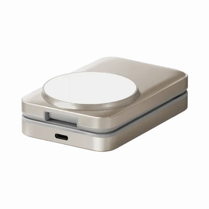 smart tech store Canada. premium tech accessories Canada. Momax 1-Charge Q.Port Qi2 3-in-1 Magnetic Wireless Charging Stand. Gallery image 2. The product is a compact, rectangular wireless charger, positioned at a slight angle in the frame. It features a smooth, metallic gold finish with a circular white charging pad on top. The bottom edge has a small USB-C port for charging. The background is a seamless white, enhancing the product's sleek design.