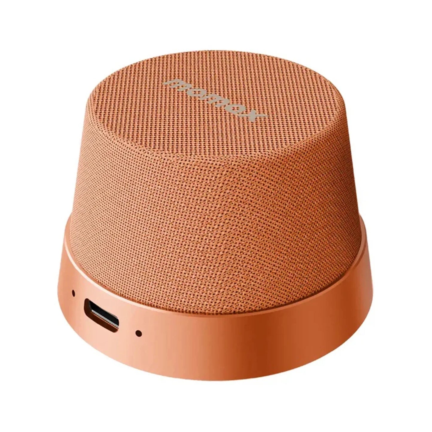 future tech gadgets Canada. premium tech accessories Canada. Momax 1-Vibe Go Magnetic Wireless Speaker. Gallery image 8. The speaker is positioned slightly off-center, showcasing its rounded, conical shape. It features a textured, warm orange fabric covering the top and sides, with a smooth, matte finish on the base. A small port is visible on the side, along with a status LED indicator. The background is a seamless white, providing a clean contrast that highlights the speaker's design.