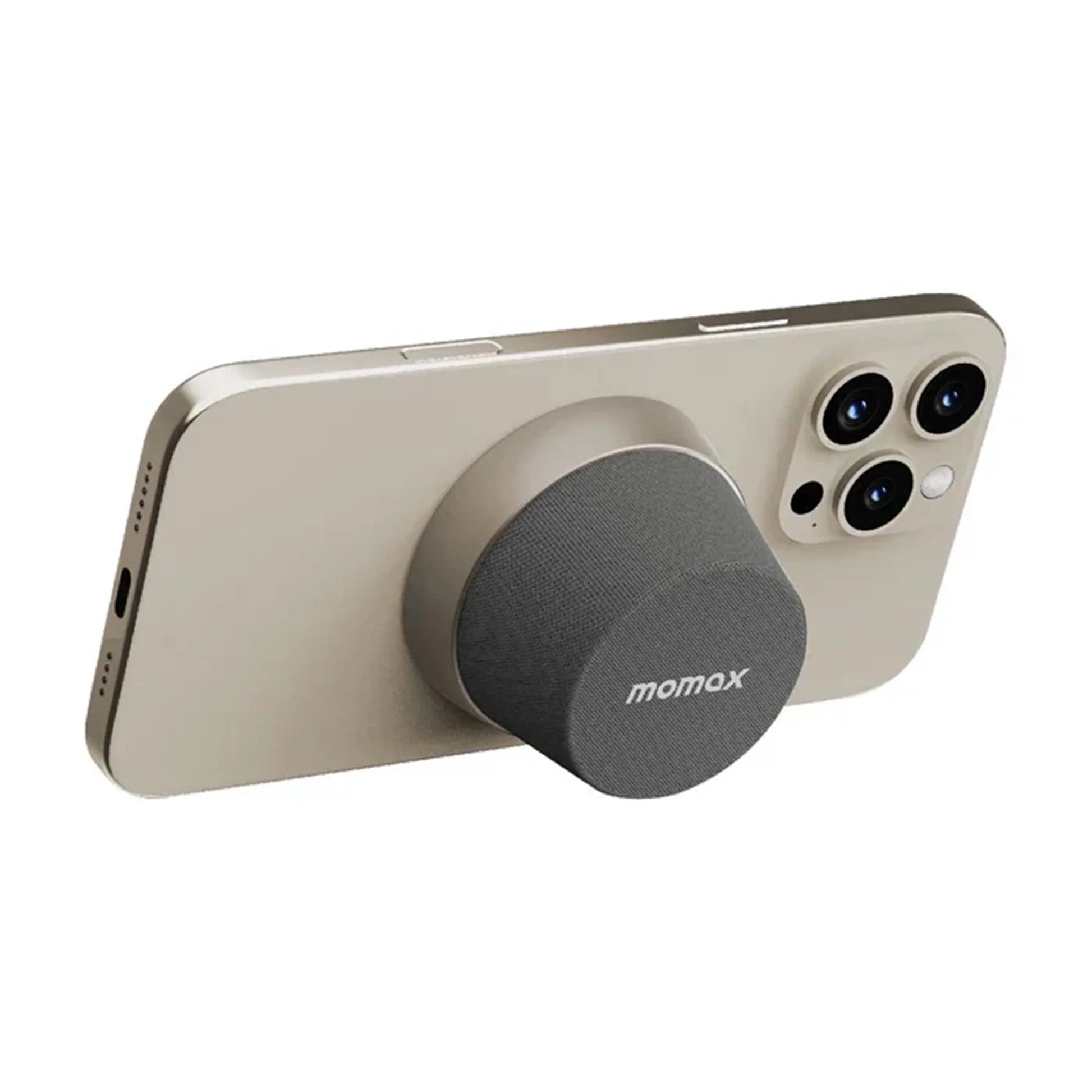 future tech gadgets Canada. premium tech accessories Canada. Momax 1-Vibe Go Magnetic Wireless Speaker. Gallery image 16. A gold smartphone is positioned at an angle, showcasing its sleek design and three rear cameras. Attached to the back is a round, dark gray accessory with a textured surface, prominently displaying the "momax" logo. The background is plain white, emphasizing the product's clean lines and modern aesthetic.