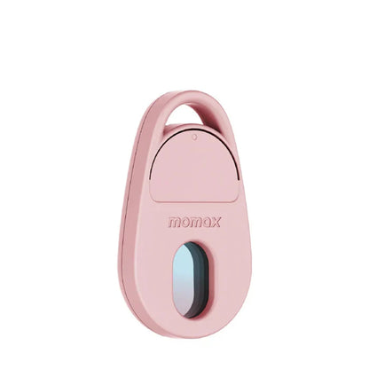 future tech gadgets Canada. smart tech store Canada. Momax Pinguard Camera Scanning Find My Locator. Gallery image 2. The product is a small, oval-shaped device in a soft pink color, positioned centrally against a white background. It features a rounded top with a small circular button and a lens opening at the bottom, which has a subtle blue tint. The brand name "momax" is embossed on the front.