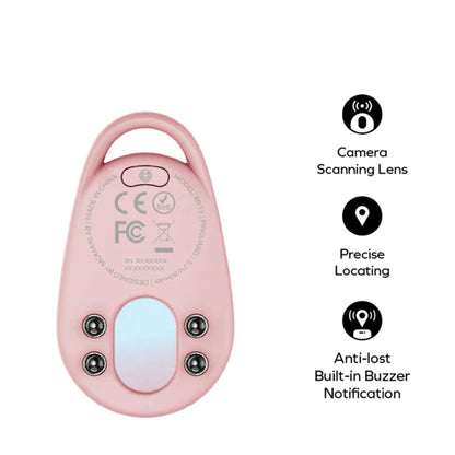 future tech gadgets Canada. smart tech store Canada. Momax Pinguard Camera Scanning Find My Locator. Gallery image 4. The product is a small, oval-shaped device in a soft pink color, positioned centrally against a seamless white background. The surface is smooth with a glossy finish, and it features a camera scanning lens at the top, along with a circular button above it. Below the lens, there are four small black sensors.