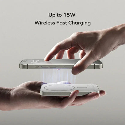 future tech gadgets Canada. premium tech accessories Canada. Momax Q.Mag X 5000mAh Wireless Battery Pack. Gallery image 9. A silver smartphone is held above a wireless charging pad, with a hand gently guiding it into position. The phone displays the text "15W" on its screen, indicating fast charging capability. The background is a soft gray, enhancing the sleek design of the products. Light beams are illustrated between the phone and the charging pad, suggesting an active charging process.