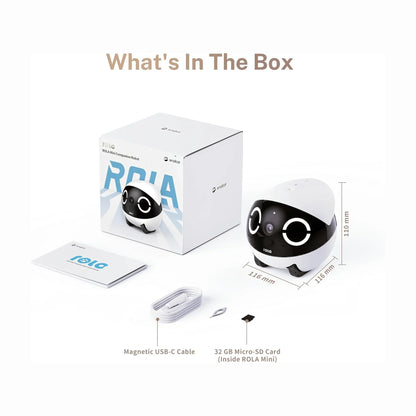 smart tech store Canada. premium tech accessories Canada. Enabot Rola Mini Companion Robot. Gallery image 9. The image features a compact, rounded robot companion, predominantly white with a glossy black front that includes large, expressive eyes and a camera lens. It is positioned to the right of a white box with blue and black graphics, labeled "ROLA Mini Companion Robot." To the left, a booklet and a magnetic USB-C cable are neatly arranged, along with a small micro-SD card.