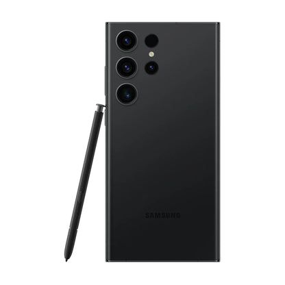 cutting edge electronics online Canada. smart tech store Canada. Premium Samsung Galaxy S23 Ultra. Gallery image 4. The smartphone is positioned centrally in the frame, showcasing its sleek black back. The camera module, featuring three lenses and a flash, is located in the upper left corner, with a glossy finish that reflects light subtly. Next to the phone, a black stylus is leaning against the device, emphasizing its functionality.