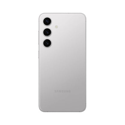 smart tech store Canada. premium tech accessories Canada. Premium Samsung Galaxy S24. Gallery image 12. The image shows a sleek, silver smartphone positioned upright and centered against a plain white background. The back of the device features three circular camera lenses arranged vertically, with a small flash located next to them. The surface of the phone has a glossy finish that reflects light softly, enhancing its modern appearance.