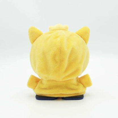 smart tech store Canada. premium tech accessories Canada. EMO Desk Companion Robot Clothes. Gallery image 3. The image features a plush toy with a rounded, yellow body and small, pointed ears. It is positioned centrally against a seamless white background, showcasing its soft, fuzzy texture. The toy has a small crown-like detail on top and is wearing a matching yellow outfit with blue soles. The lighting is bright and even, highlighting the plush material without harsh shadows.