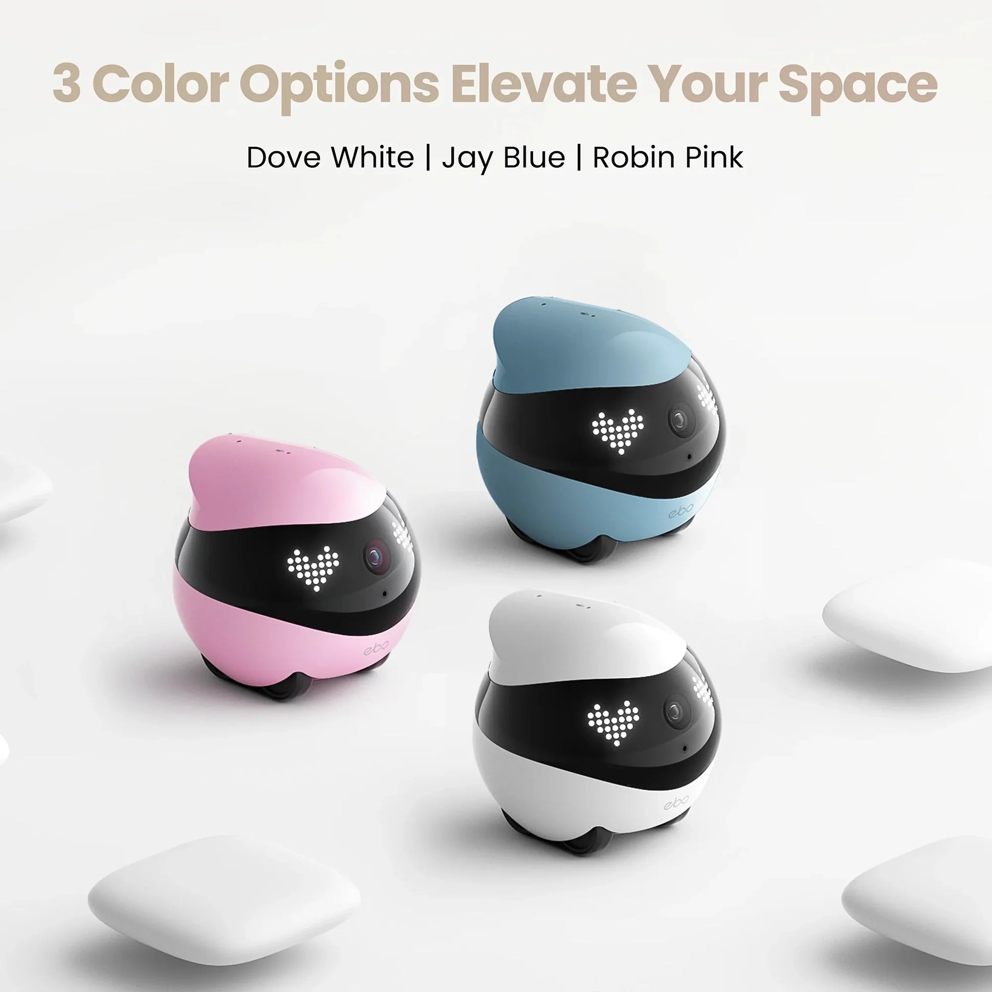 smart tech store Canada. premium tech accessories Canada. Enabot Ebo Air 2 Companion Robot. Gallery image 8. Three rounded robotic devices are displayed on a seamless light background, each in a different color: Dove White, Jay Blue, and Robin Pink. The devices have a glossy finish with a black band around the middle featuring a small camera and LED lights that form a heart shape. They are positioned closely together, with the white device slightly in front of the others.