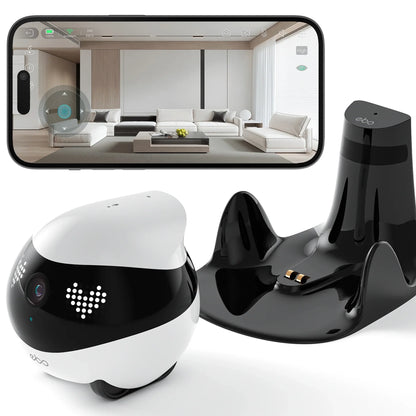 smart tech store Canada. premium tech accessories Canada. Enabot Ebo Air 2 Companion Robot. Gallery image 1. A small, round robotic device in black and white is positioned in the foreground, showcasing its glossy finish and playful design. It features a camera lens and LED lights that create a friendly appearance. To the right, a sleek black charging dock with two metal connectors is visible.