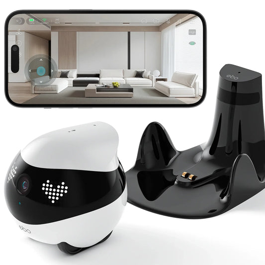 smart tech store Canada. premium tech accessories Canada. Enabot Ebo Air 2 Companion Robot. Gallery image 1. A small, round robotic device in black and white is positioned in the foreground, showcasing its glossy finish and playful design. It features a camera lens and LED lights that create a friendly appearance. To the right, a sleek black charging dock with two metal connectors is visible.