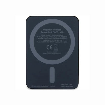 cutting edge electronics online Canada. premium tech accessories Canada. Guess Powerbank Magsafe Metal Script Logo 5000mAh 15W Black. Gallery image 1. The image shows a magnetic wireless power bank positioned flat against a light background. The device features a sleek, dark gray surface with a circular magnetic charging area in the center. On the back, various specifications and a logo are printed in white text, including the model number and battery capacity.