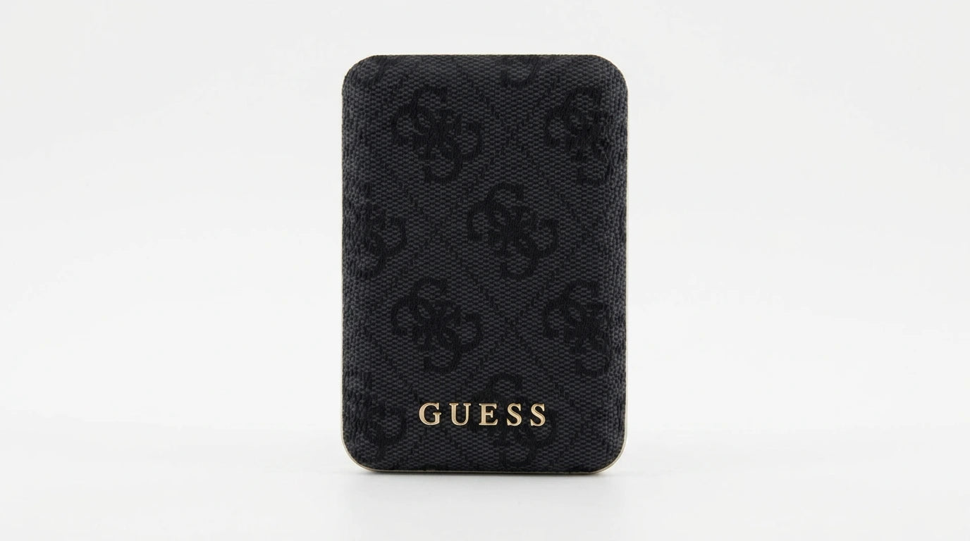 future tech gadgets Canada. premium tech accessories Canada. Guess BP MagSafe Case + PWB 5000mAh 4G. Gallery image 10. The product is a black cardholder, centered in the frame against a seamless white background. The cardholder features a textured fabric with a subtle pattern of the brand's logo, which is embossed in a darker shade of black. At the bottom, the word "GUESS" is prominently displayed in gold lettering, adding a touch of elegance.