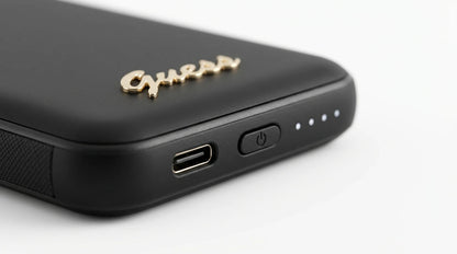 cutting edge electronics online Canada. premium tech accessories Canada. Guess Powerbank Magsafe Metal Script Logo 5000mAh 15W Black. Gallery image 9. Lines name one specific SKU—never substitute a generic lookalike from the category. After review passes, each render should still read as a fresh studio viewpoint of that same physical unit.