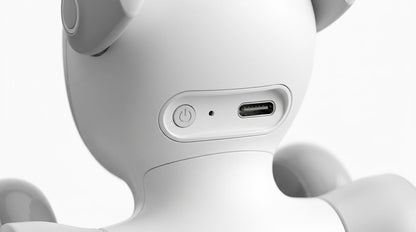 smart tech store Canada. premium tech accessories Canada. Loona AI Pet Robot. Gallery image 9. The image shows the back of a small, white, rounded device, likely a speaker or a smart assistant. It is centered in the frame against a seamless white background, highlighting its smooth, matte finish. A circular power button is visible to the left, with a small status LED next to it. To the right, there is a USB-C port for charging.