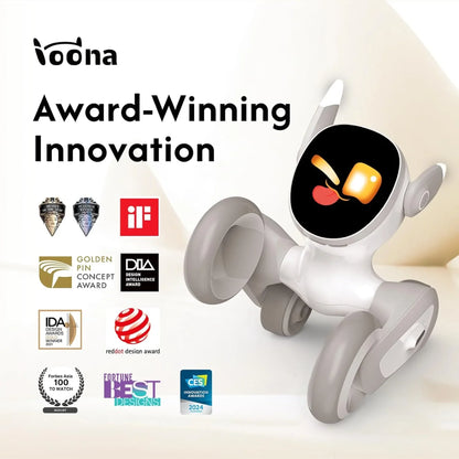 smart tech store Canada. premium tech accessories Canada. Loona AI Pet Robot. Gallery image 6. The image features a small, playful robot toy positioned at an angle on a light, neutral background. The robot has a glossy white body with gray accents and large, expressive eyes displaying a playful emoji face. It is supported by four rounded wheels, giving it a friendly appearance.