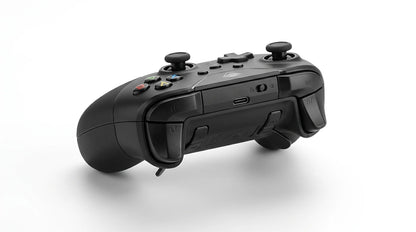 future tech gadgets Canada. premium tech accessories Canada. Machenike G5 Pro V2 Tri-Mode Controller. Gallery image 8. The image features a black gaming controller positioned at a slight angle, showcasing its back side. The controller is centered against a seamless white background, highlighting its sleek design. The surface is matte with textured grips on the sides for better handling.