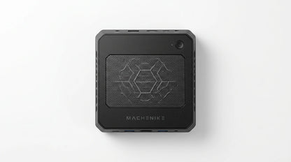 future tech gadgets Canada. gaming handheld PC Canada. Machenike GTX PH94H28 Mini PC. Gallery image 3. The product is a compact black computer unit, centered in the frame against a seamless white background. The top features a textured hexagonal mesh pattern, with the brand name "MACHENIKE" printed in bold letters near the bottom edge. A small power button is located in the upper right corner.
