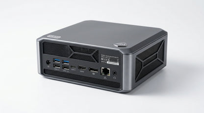 future tech gadgets Canada. gaming handheld PC Canada. Machenike GTX PH94H28 Mini PC. Gallery image 7. The compact desktop computer is positioned at an angle, showcasing its rear ports and vents. The device features a sleek, matte gray finish with a brushed metal accent on the top edge. Various ports, including multiple USB connections, HDMI, and an Ethernet jack, are visible on the back, along with a small logo in the upper corner.