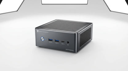 future tech gadgets Canada. gaming handheld PC Canada. Machenike GTX PH94H28 Mini PC. Gallery image 9. The compact desktop computer is positioned slightly angled to the right, showcasing its sleek design against a seamless white background. The body is a brushed dark gray metal with a matte finish, featuring a mesh top for ventilation. On the front, there are three USB 3.0 ports, a USB-C port, and a headphone jack, along with a blue power button that is illuminated.