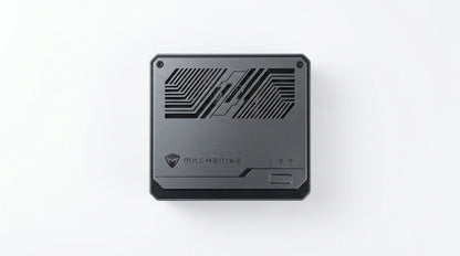 future tech gadgets Canada. smart tech store Canada. Machenike GTX PH94H48 Mini PC. Gallery image 4. The product is centered in the frame against a seamless white background. It features a sleek, matte black exterior with a brushed metal texture. The top surface displays a geometric pattern of vents for airflow, alongside the "MACHENIKE" logo and a power button on the right side. Three small status indicator lights are visible near the logo, suggesting connectivity options.