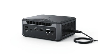 future tech gadgets Canada. smart tech store Canada. Machenike GTX PH94H48 Mini PC. Gallery image 8. The product is a compact, rectangular device positioned at an angle, showcasing its rear side. It features a matte black finish with silver accents and a textured top surface. The back panel displays multiple ports, including two USB-A, one USB-C, an HDMI, a DisplayPort, an Ethernet port, and a DC power input. A power cable is plugged into the DC port.
