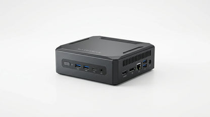 future tech gadgets Canada. smart tech store Canada. Machenike GTX PH94H48 Mini PC. Gallery image 10. The compact black computer is positioned at a slight angle, showcasing its front and side. It features a textured surface with a matte finish and a prominent logo on the top. The front panel includes a power button, multiple USB ports, and an audio jack, while the side displays additional ports, including HDMI and USB-C. The background is a seamless white, enhancing the product's sleek design.