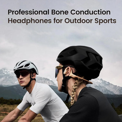 future tech gadgets Canada. smart tech store Canada. Mojawa Purra Run Bone Conduction Running Headphones. Gallery image 2. Two cyclists are positioned in the foreground, facing each other against a backdrop of mountains under a cloudy sky. The male cyclist on the left wears a light gray helmet and sunglasses, with a fitted white shirt. The female cyclist on the right has a black helmet and gold-accented sunglasses, with her hair styled in a braid.