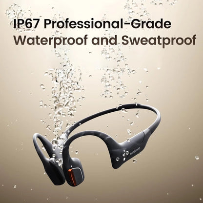 future tech gadgets Canada. smart tech store Canada. Mojawa Purra Run Bone Conduction Running Headphones. Gallery image 6. The image features a pair of sleek, black waterproof headphones submerged in water, with bubbles rising around them. The headphones are positioned centrally, showcasing their lightweight design and open-ear style. A small orange accent is visible on one side, adding a pop of color. The background is a soft, neutral tone, enhancing the focus on the product.