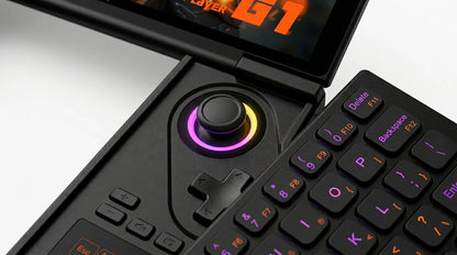 future tech gadgets Canada. wireless audio Canada. ONEXPLAYER G1 2TB AMD Ryzen™ AI 9 HX 370 Ultimate Gaming Handheld Gaming Console Versatile Laptop. Gallery image 9. The image features a gaming controller and keyboard combination, angled slightly to the right. The controller has a central joystick with a colorful LED ring, transitioning from purple to yellow, and is surrounded by a textured black surface.