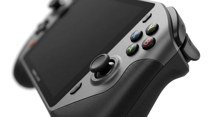 future tech gadgets Canada. gaming handheld PC Canada. ONEXPLAYER X1 PRO 2TB AMD Ryzen™ AI 9 HX 370, 10.95'' 3-In-1 Gaming Handheld PC. Gallery image 9. The image shows a gaming controller angled slightly to the right, with a matte gray body and textured black grips. The controller features a central touchscreen area, surrounded by various buttons, including four colored action buttons labeled A, B, X, and Y, and two thumbsticks.