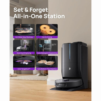 smart tech store Canada. premium tech accessories Canada. 3i Smart Robot Vacuum and Mop (P10 Ultra). Gallery image 2. The image features a sleek, black all-in-one cleaning station positioned against a light-colored wall, with a wooden floor beneath. The station has a glossy finish and a blue LED light on the front, indicating power. A robotic vacuum sits at the base, partially visible on a black mat.