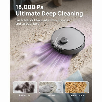 smart tech store Canada. premium tech accessories Canada. 3i Smart Robot Vacuum and Mop (P10 Ultra). Gallery image 4. A round, gray robotic vacuum cleaner is positioned slightly off-center on a light-colored carpet, actively cleaning. The vacuum features a prominent button on top and has a sleek, modern design with a matte finish. Purple light emanates from the front, highlighting dirt and debris being lifted, including hair, cat litter, and cereal crumbs displayed in three small images below.