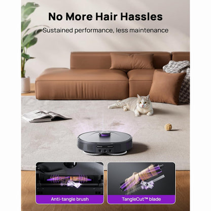 smart tech store Canada. premium tech accessories Canada. 3i Smart Robot Vacuum and Mop (P10 Ultra). Gallery image 5. A robotic vacuum sits on a light beige carpet in a cozy living room, centered in the frame. The vacuum features a sleek black body with a purple accent on top. In the background, a brown sectional sofa with plush cushions is visible, along with a gray throw blanket draped over one arm. A playful cat lounges nearby, and a small ball is on the carpet.
