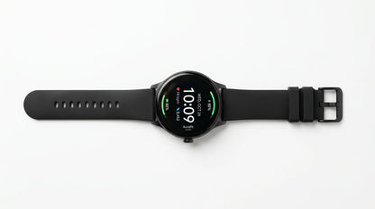 smart tech store Canada. premium tech accessories Canada. Techtron Aurafit AM23 Smart Watch. Gallery image 4. The smartwatch is centered in the frame, lying flat against a seamless white background. Its round, glossy black face displays the time, date, and various health metrics in bright colors, with green and red indicators. The strap is made of matte black rubber, featuring a series of holes for adjustment and a metal buckle on one end.