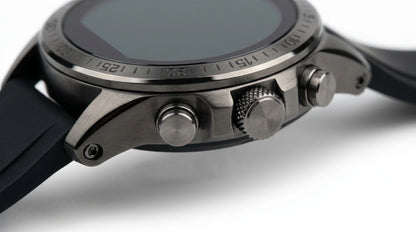 future tech gadgets Canada. smart tech store Canada. Techtron FAMO63 Fashion Smart Watch. Gallery image 9. The image shows a close-up view of a smartwatch angled slightly to the right. The watch features a matte black silicone strap and a metallic silver case with a brushed finish. Prominent on the right side are two buttons and a textured crown, which adds a tactile element. The watch face is dark and reflective, with a subtle bezel marked with numbers.