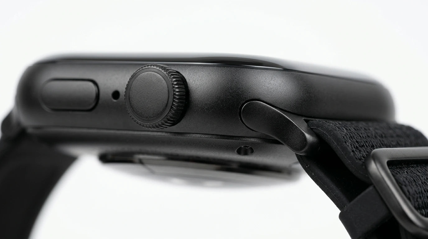 smart tech store Canada. premium tech accessories Canada. Techtron SWH18 (T52 / T67) Smart Watch. Gallery image 5. The image shows a close-up view of a black smartwatch, angled slightly to the right. The watch features a textured black strap and a round, glossy watch face. Prominent on the side are a circular crown and a button, both in a matte finish, with a small microphone hole nearby. The background is a seamless white, enhancing the watch's sleek design.
